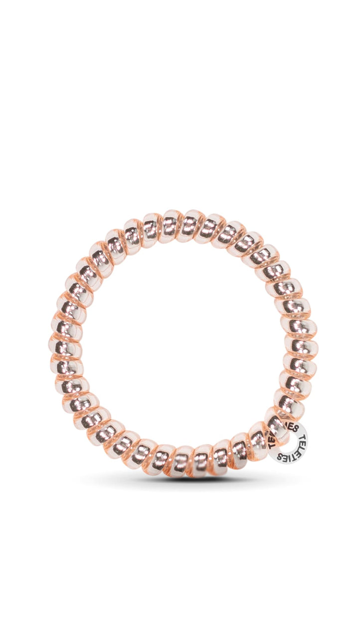Rose gold beaded bracelet with a circular clasp and logo.