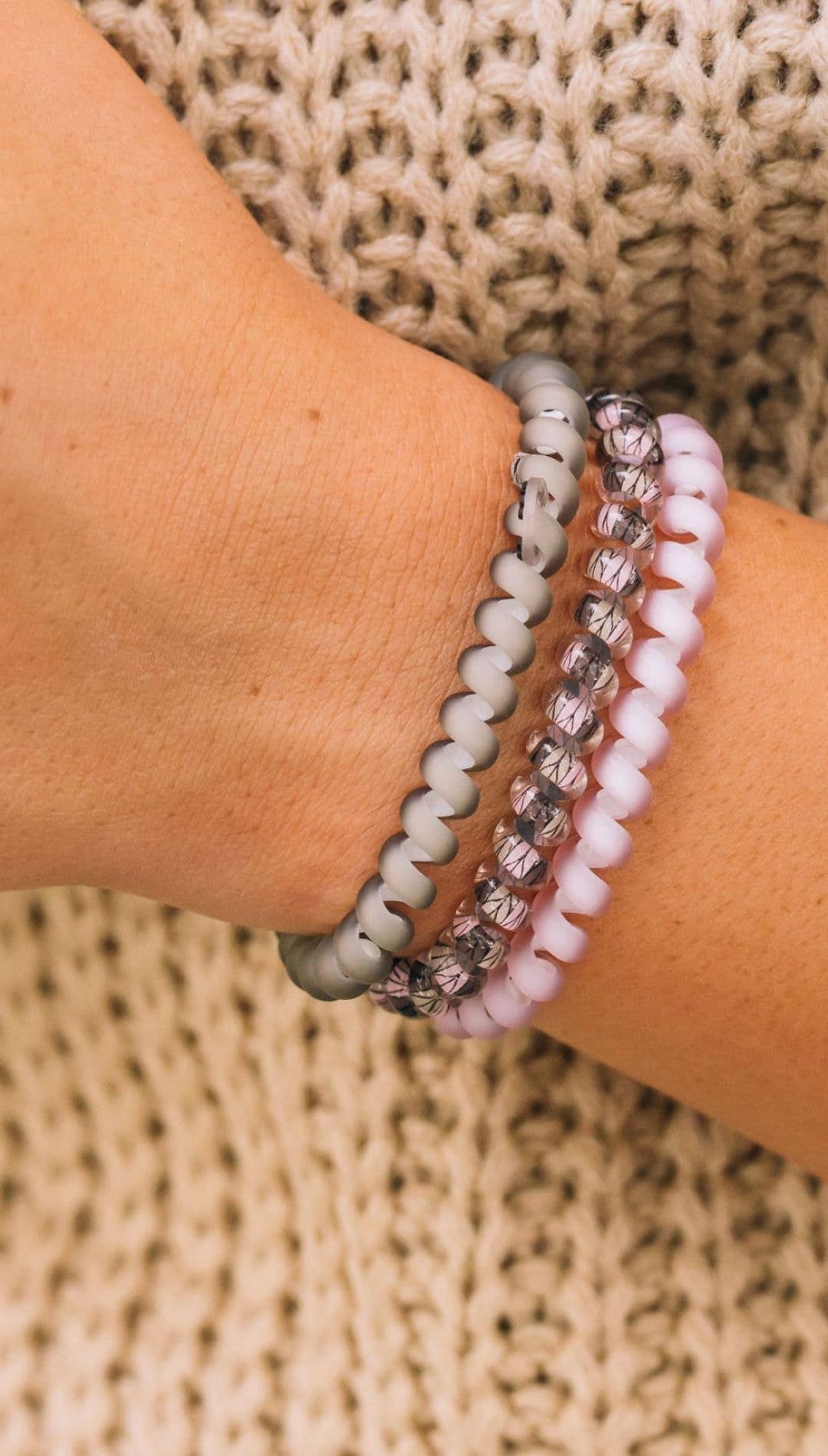Three-layered beaded bracelet set with white, gray and purple beads, silver accents, and a matte finish.