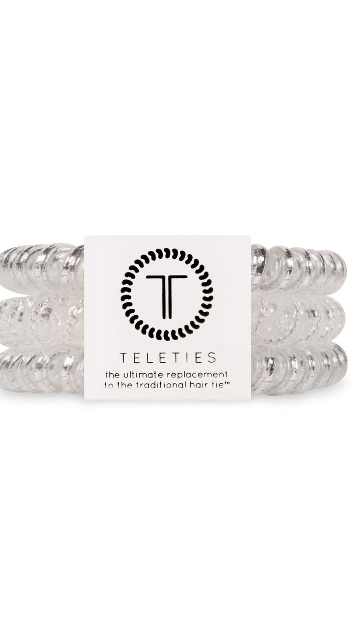 Silver beaded hair ties set with clear beads and a white card.