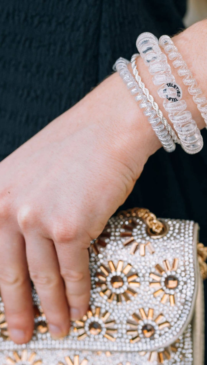 Clear plastic beaded bracelet with floral pattern and silver accents.
