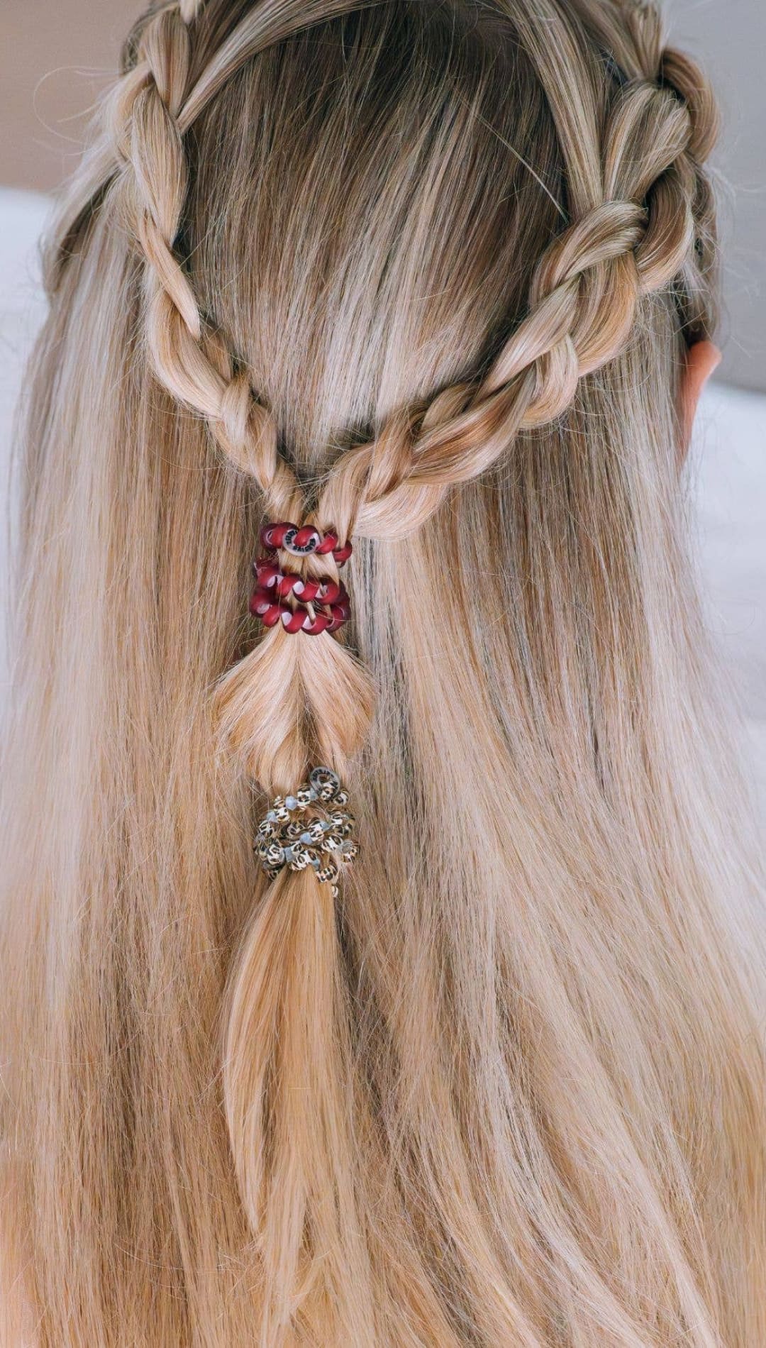 Braided hair with red and gold beads