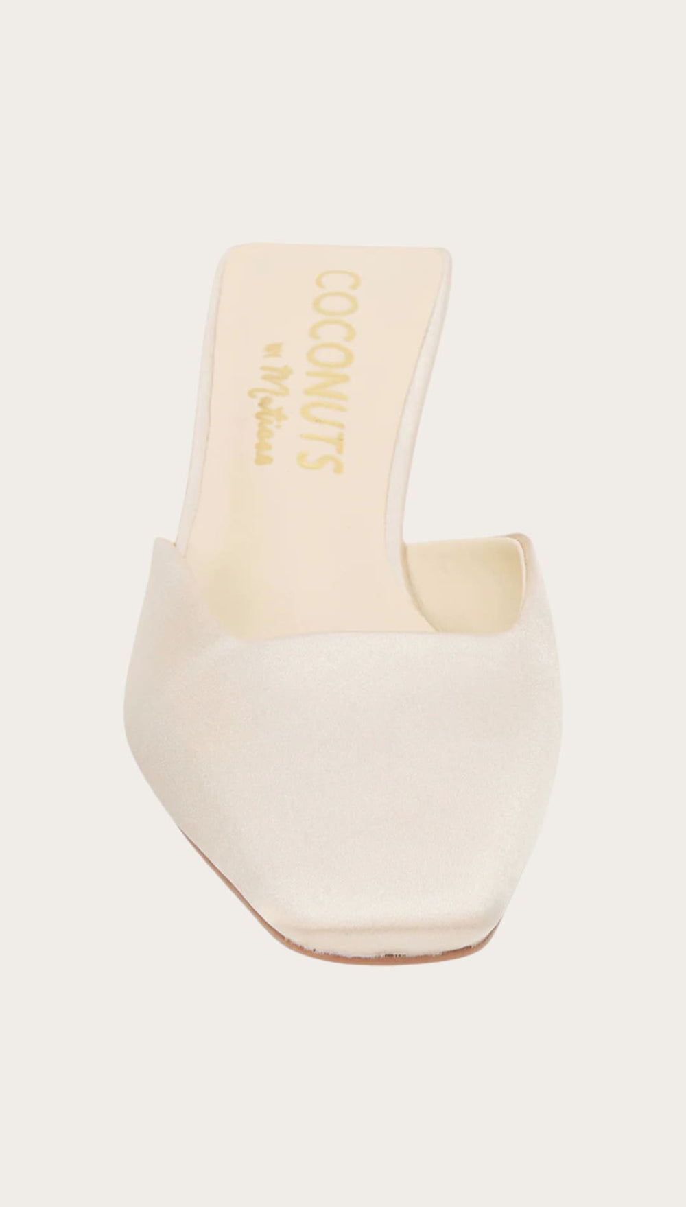 Cream-colored square-toe mule.
