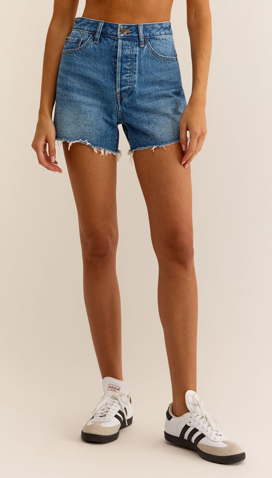 High-waisted denim shorts with frayed hem.