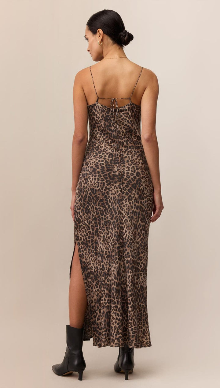 Leopard print slip dress with high slit and thin straps.