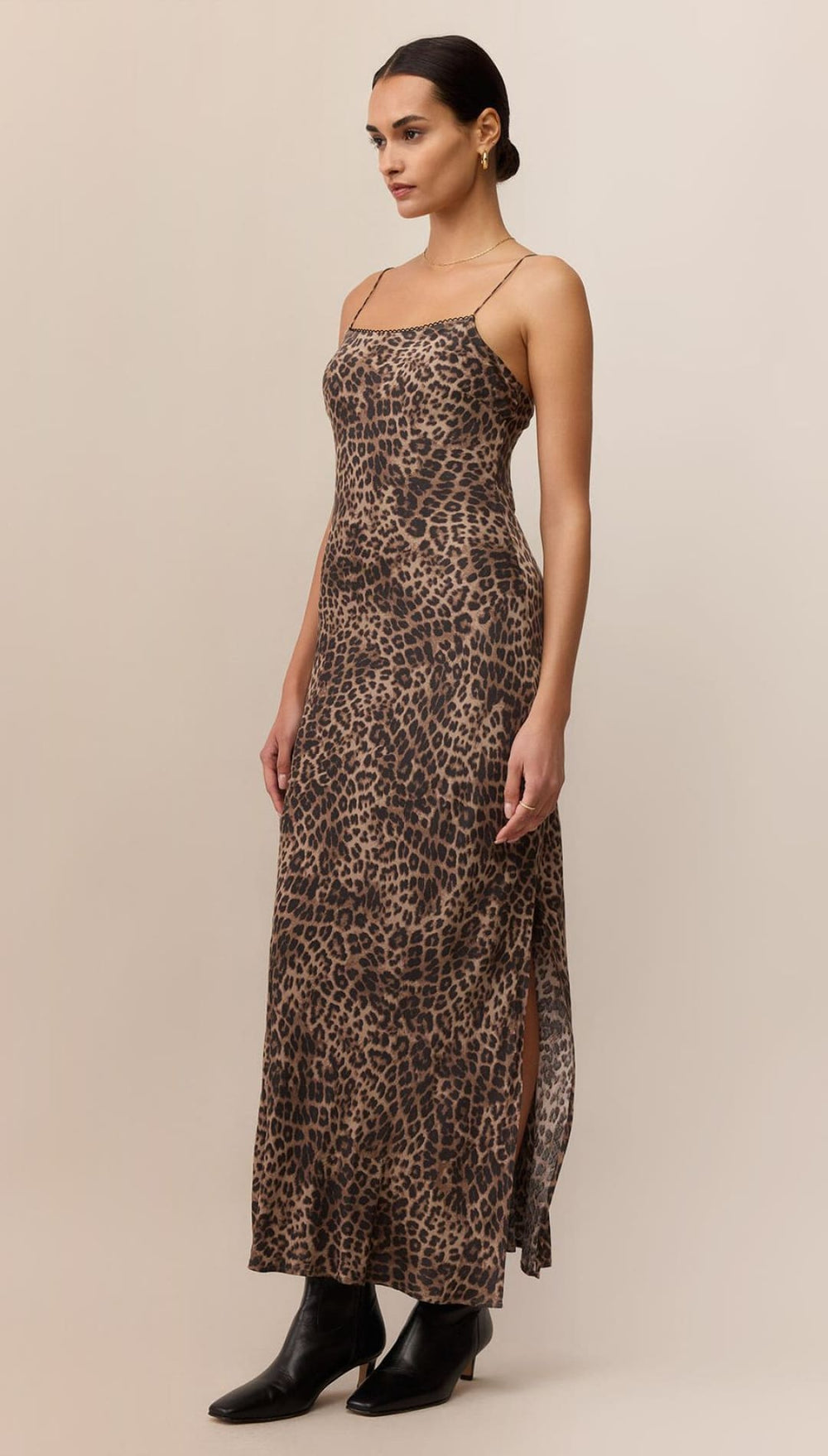 Leopard print slip dress with black leather boots.