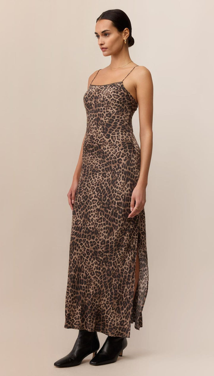 Leopard print slip dress with black leather boots.
