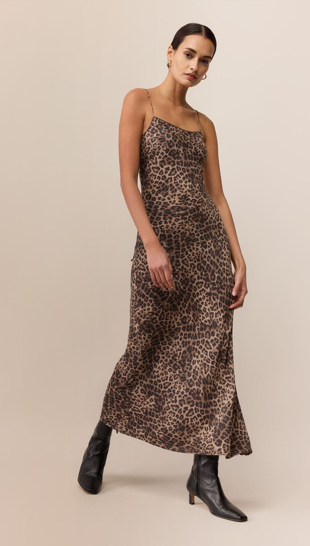 Leopard print slip dress with thin straps and high heels.