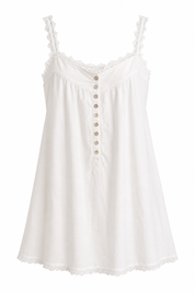 White sleeveless dress with button details on a white background