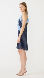 A navy blue polka dot dress with light blue ruffled shoulder accents.