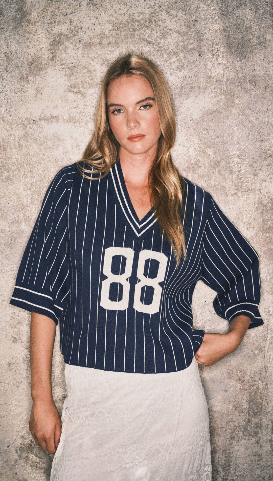 Navy blue pinstriped baseball jersey with white number 88 and fur trim, likely from a sportswear brand.