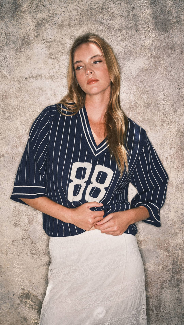 Navy blue pinstripe baseball jersey with white number 88 and lace skirt.