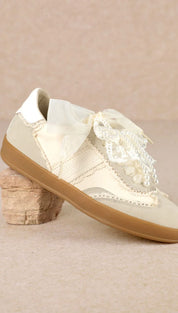 Cream lace brogue shoe with gum sole and bow detail.