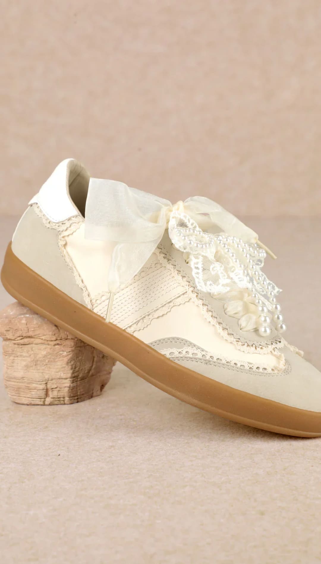 Cream lace brogue shoe with gum sole and bow detail.