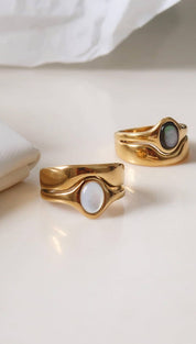 Gold-toned rings with smooth, flowing bands and oval-shaped mother-of-pearl inlays.