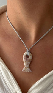 Fish-shaped stone pendant necklace.