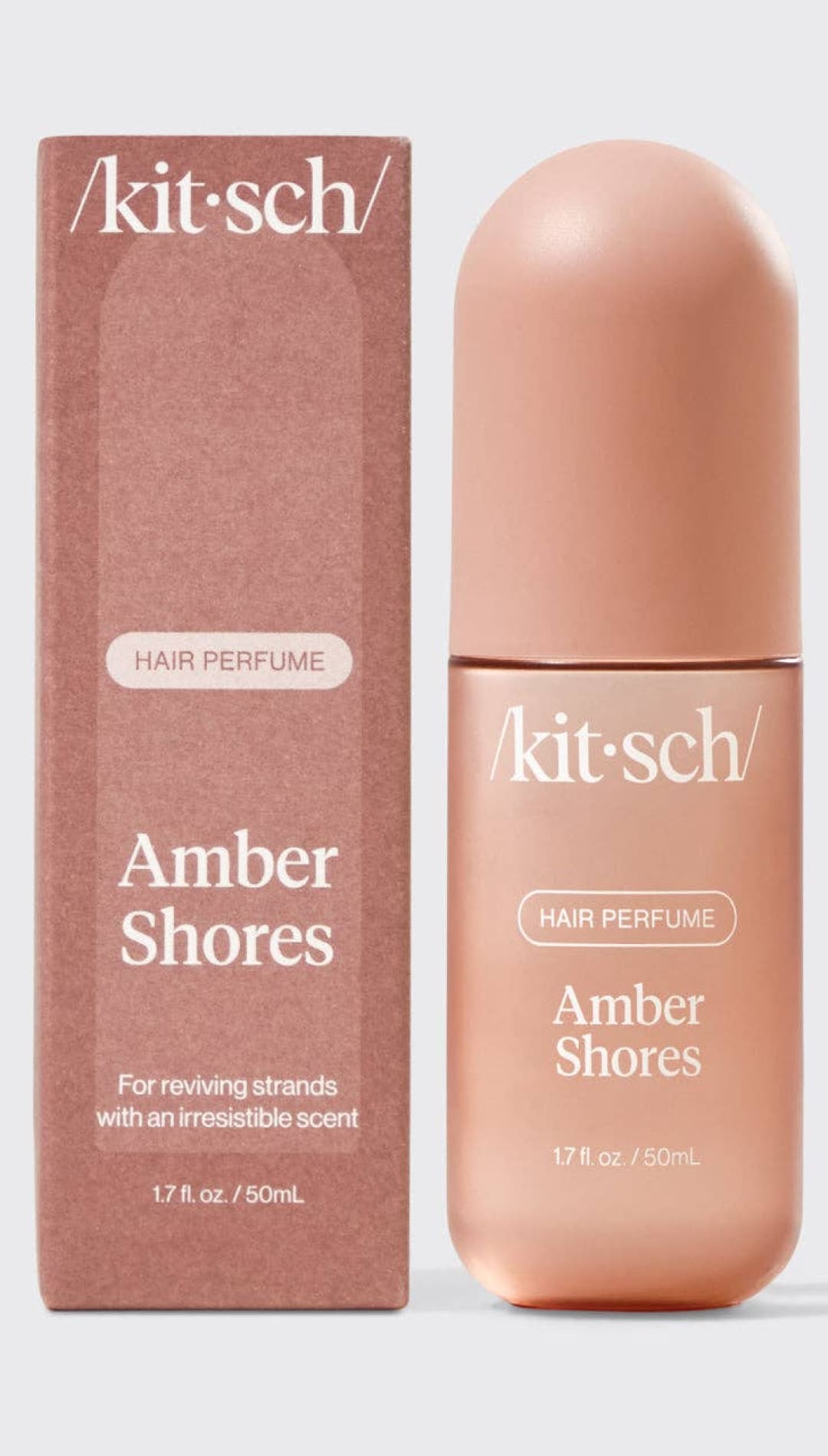 Amber shores hair perfume bottle with rose gold cap and packaging.