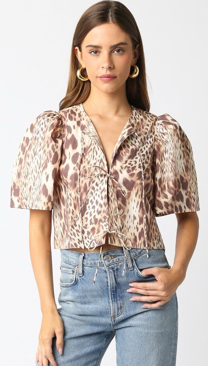 Cropped animal print blouse with puff sleeves and button front.