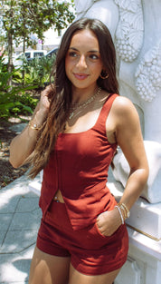 Woman in a rust-colored two-piece outfit.