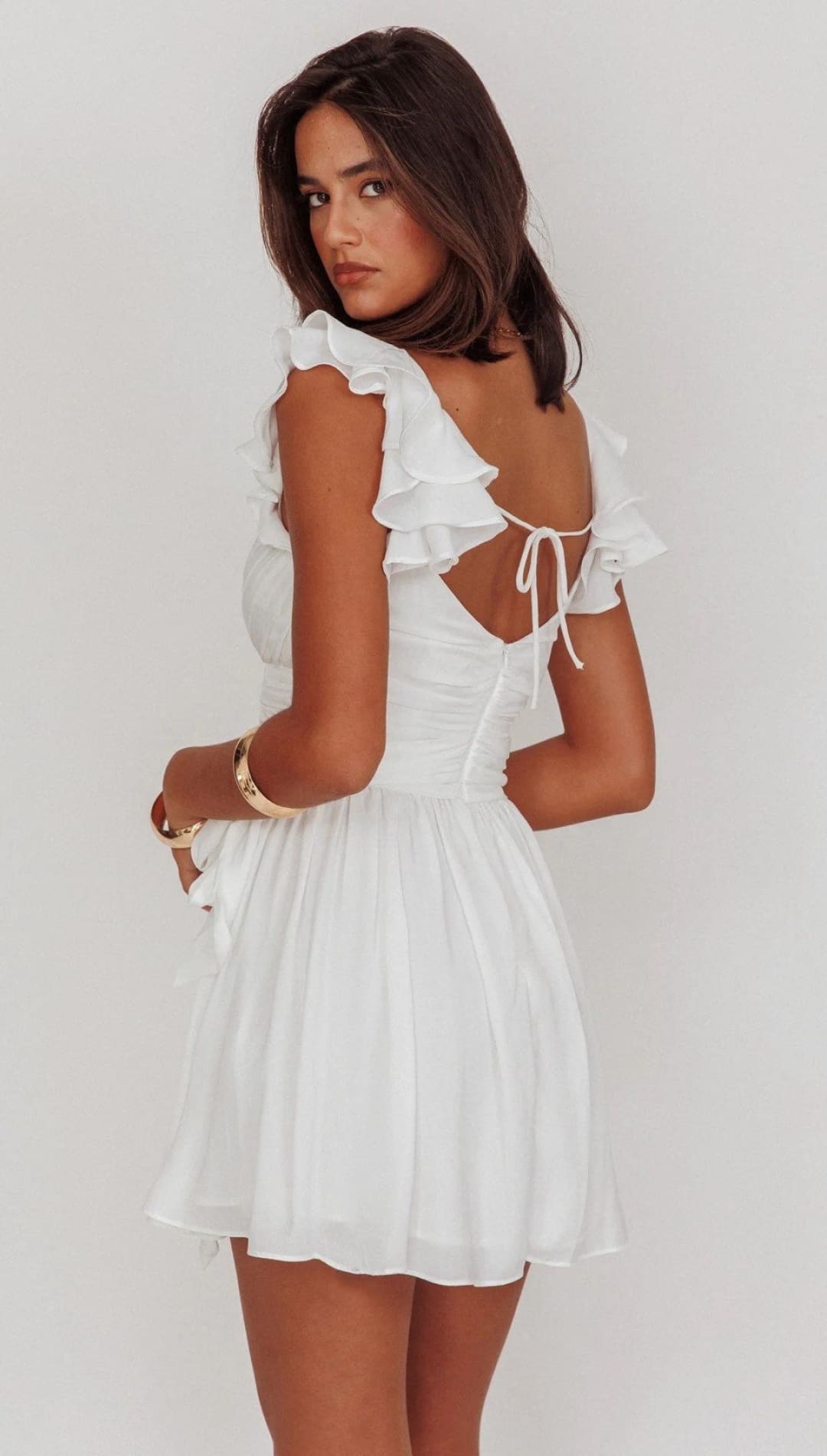 White ruffled mini dress.