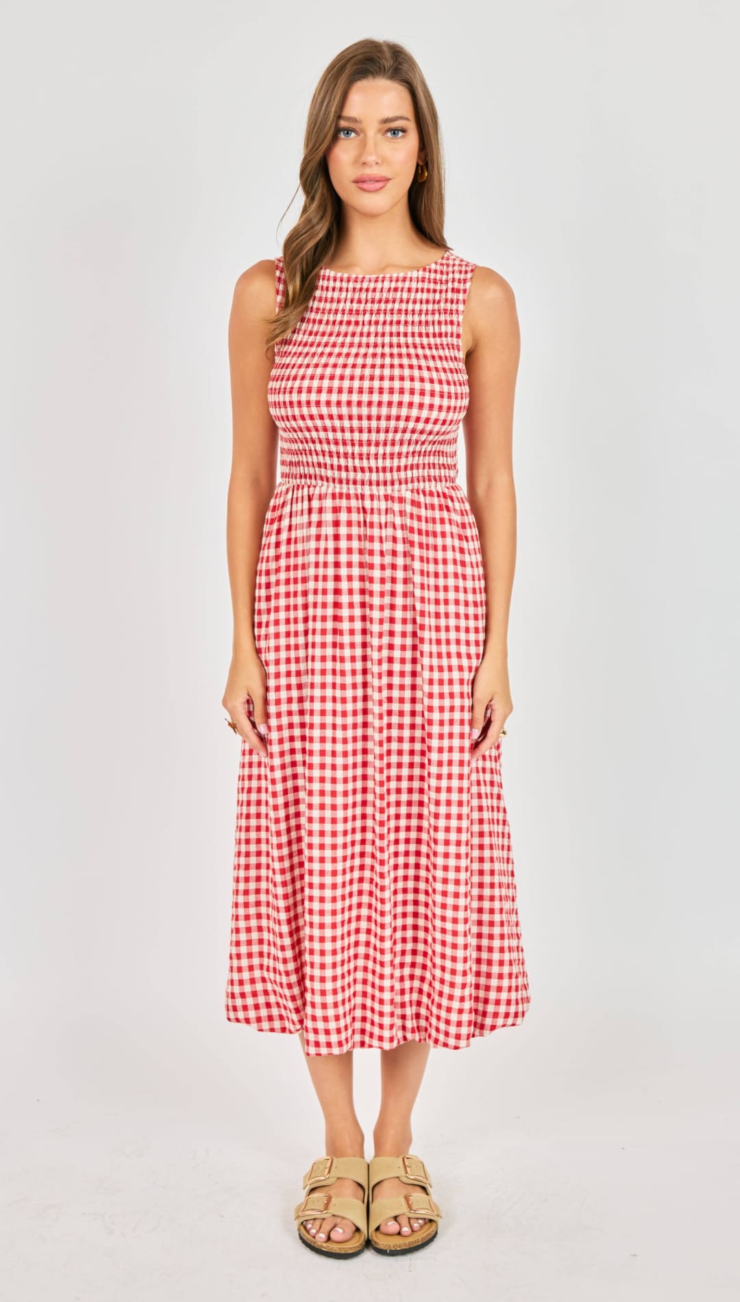 A red and white gingham sleeveless midi dress with a smocked waistband.