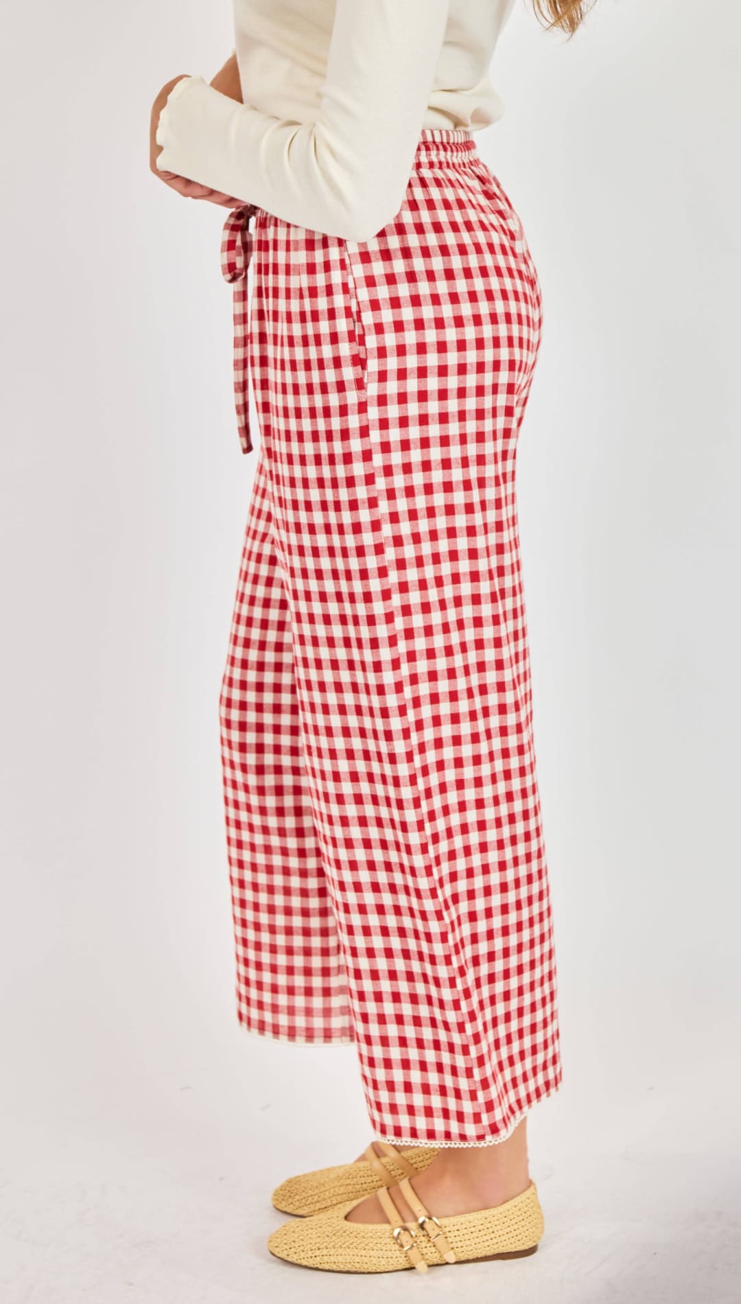 Red and white gingham wide-leg trousers with a drawstring waist.