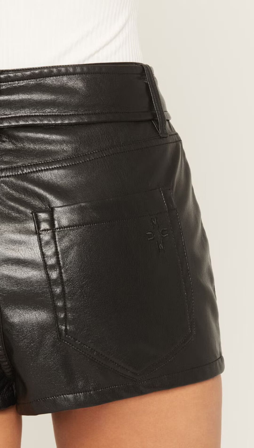 Black leather high-waisted shorts with a shiny finish and belt loops.