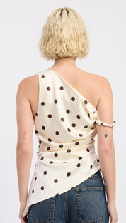 Cream-colored satin one-shoulder top with black polka dots and a draped, asymmetrical design.