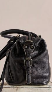 Black leather crossbody bag with a textured surface, metal buckle closure, and adjustable strap.