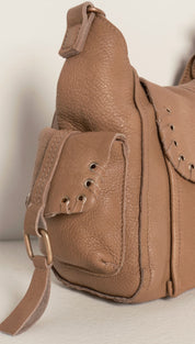 Tan leather hobo bag with stitched detailing and metal hardware.