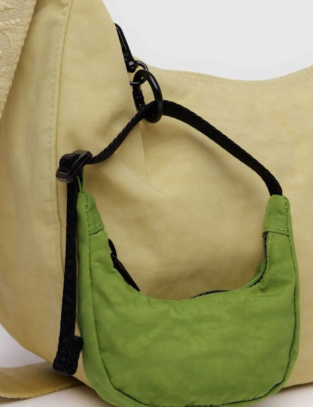 Beige hobo bag with green mini-purse.