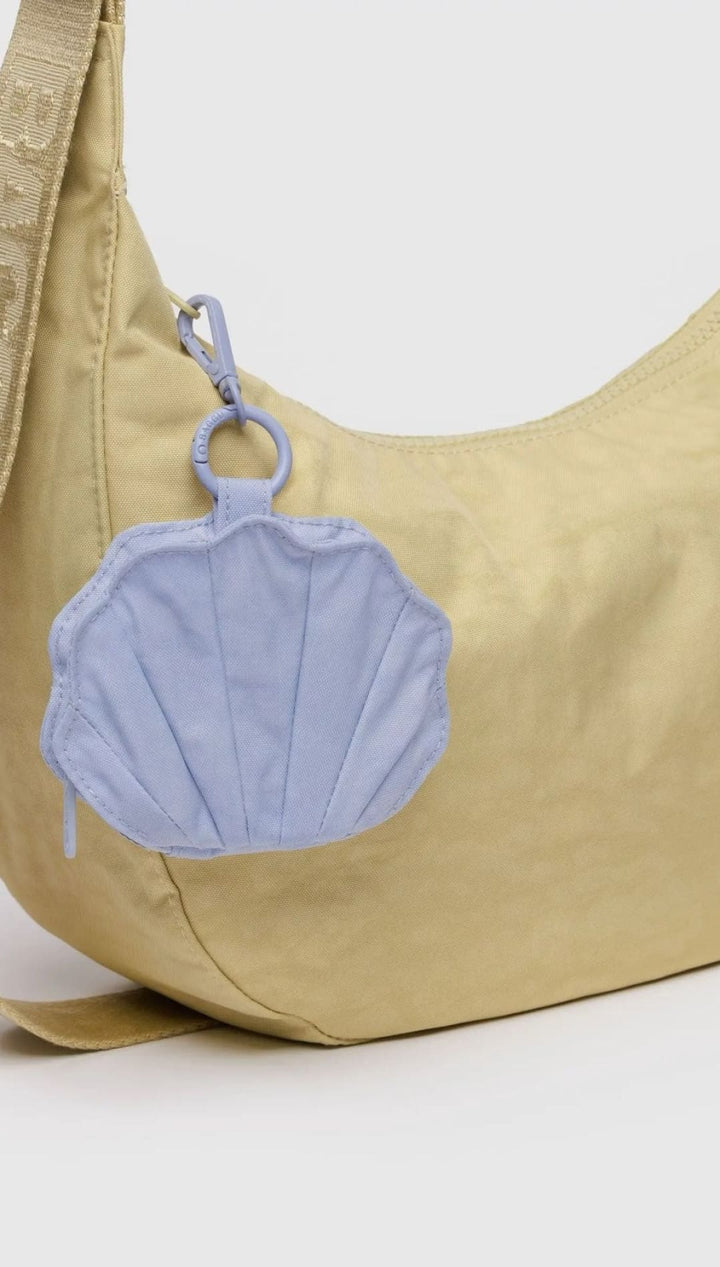 Beige shoulder bag with seashell coin purse.