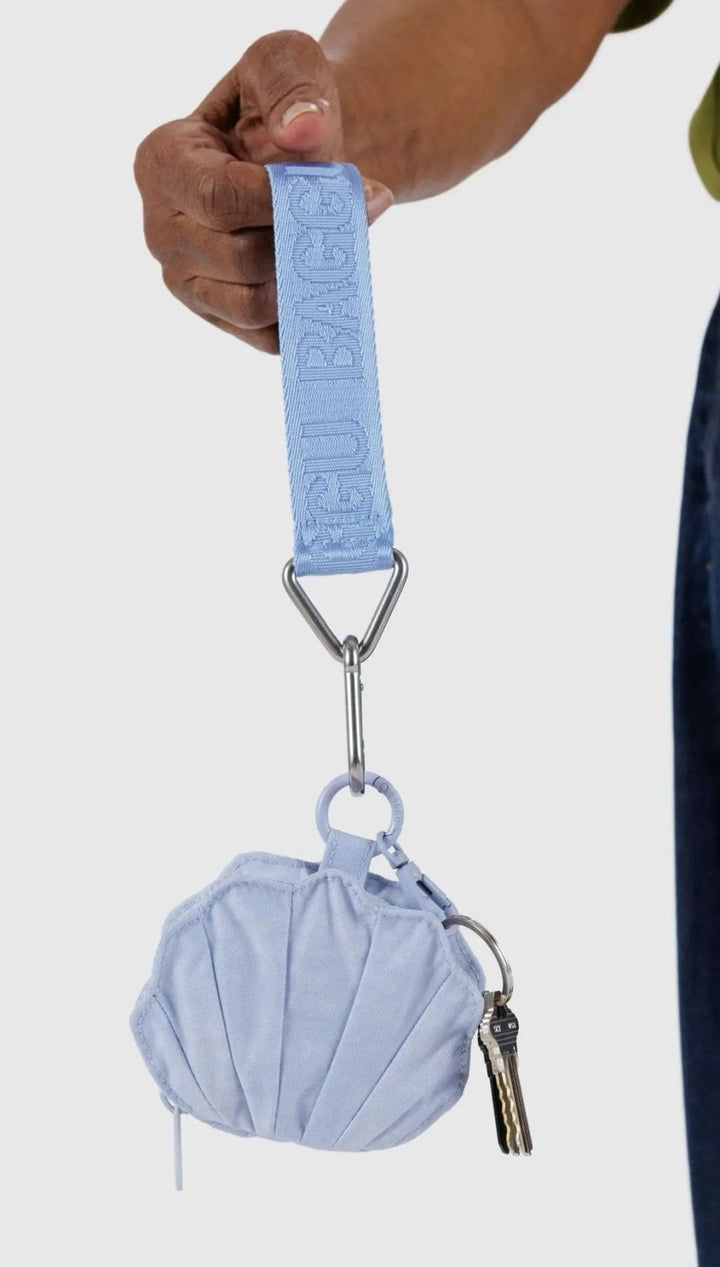 Light blue shell-shaped coin purse with wrist strap.