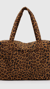 Leopard print tote bag with brown and black spots on a tan background, made of fabric.