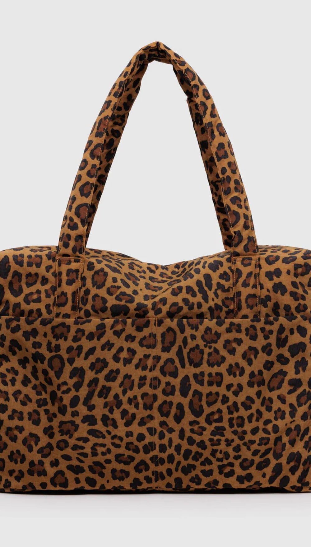 Leopard print tote bag with brown and black spots on a tan background, made of fabric.