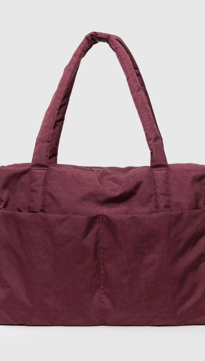 Maroon tote bag with two exterior pockets and a drawstring closure.