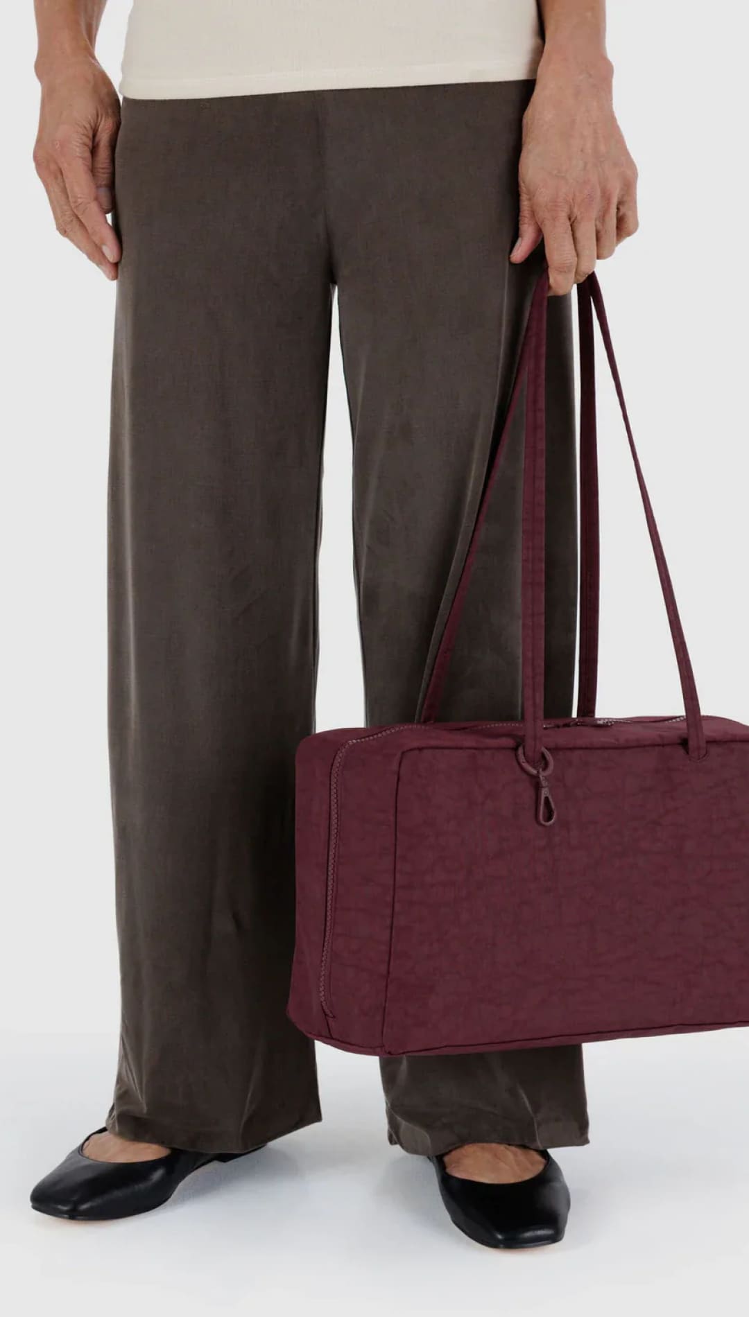 Burgundy textured tote bag with leather handles and drawstring closure.
