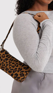 Leopard print crossbody bag with adjustable strap and metallic hardware.