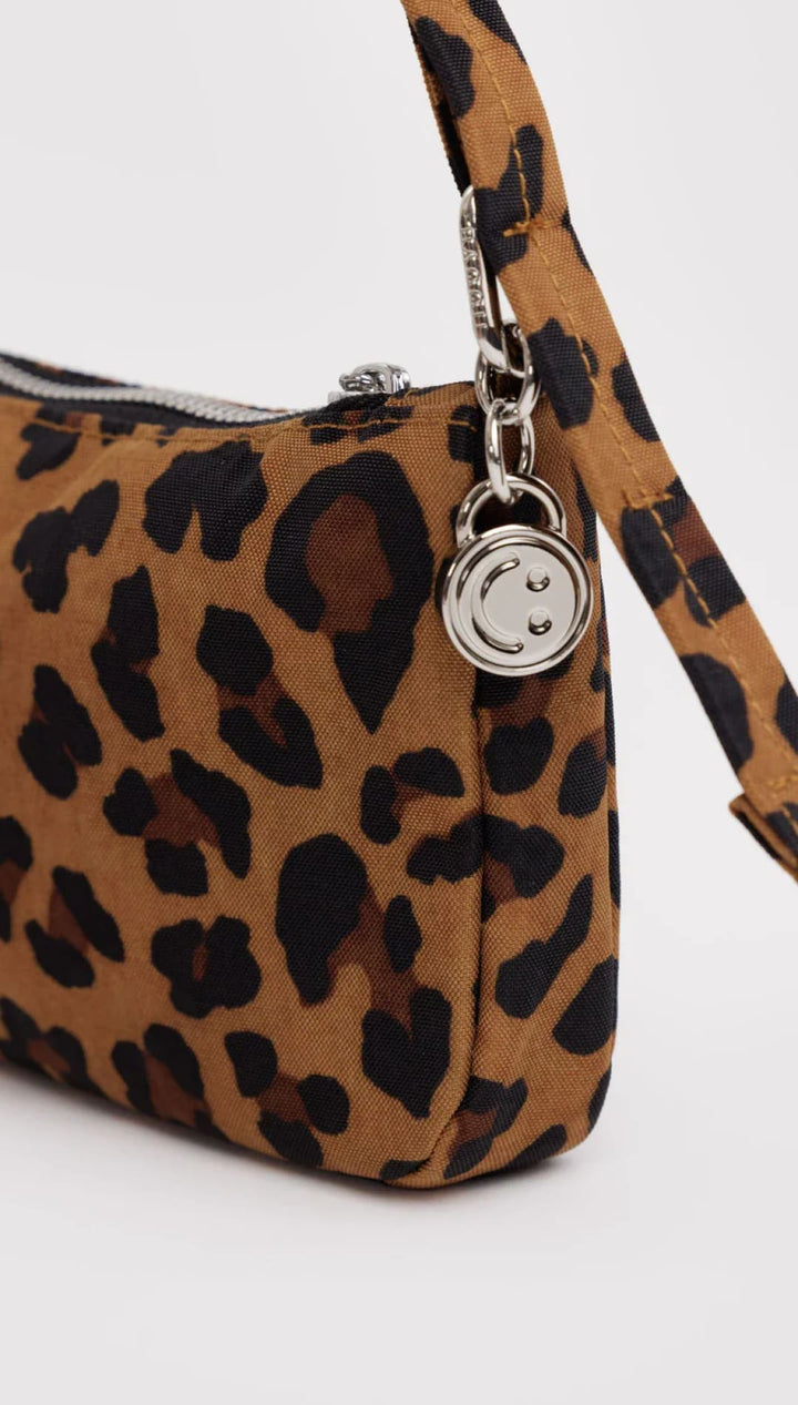 Leopard print shoulder bag with silver charm.