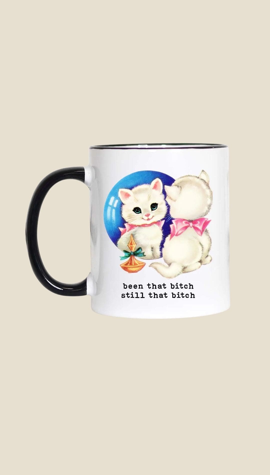 Ceramic mug with black handle and rim, featuring a cartoon cat design.
