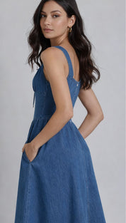 Blue denim dress with thin straps and side pockets