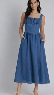 A denim midi dress with a square neckline, gathered bodice and front tie detail.