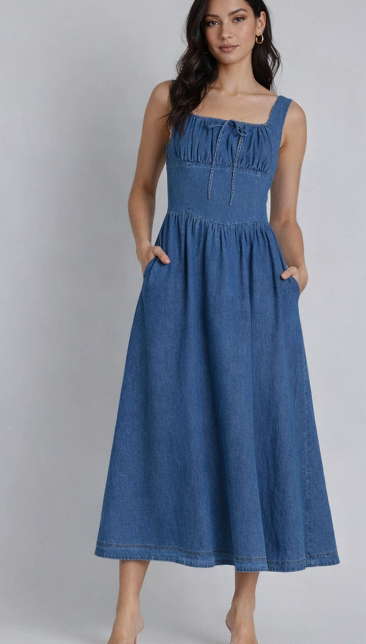 A denim midi dress with a square neckline, gathered bodice and front tie detail.