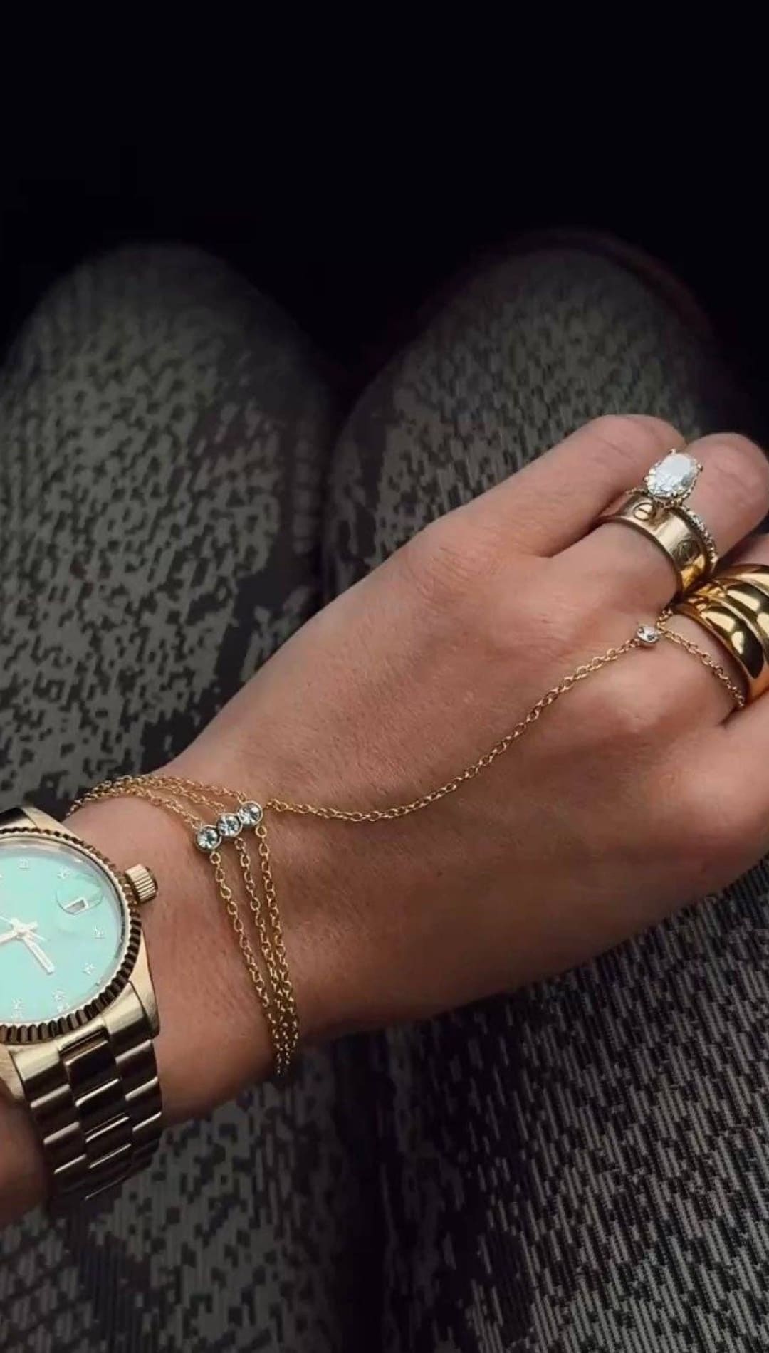 Gold-tone watch with a mint green dial and stainless steel bracelet.