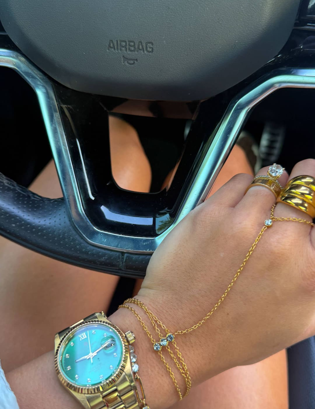 Gold-tone wristwatch with a turquoise dial and diamond accents on the bezel and bracelet.