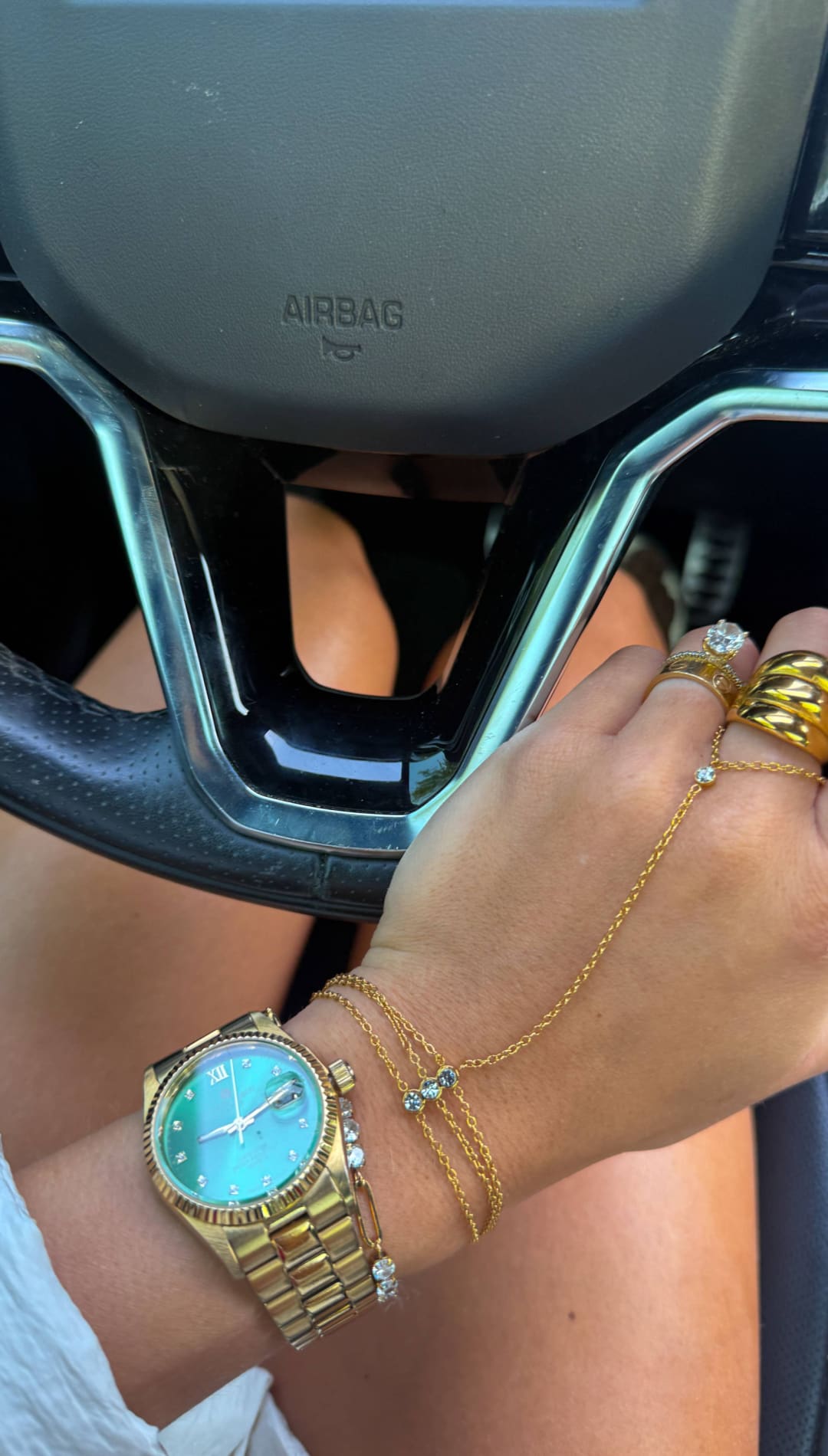 Gold-tone wristwatch with a turquoise dial and diamond accents on the bezel and bracelet.