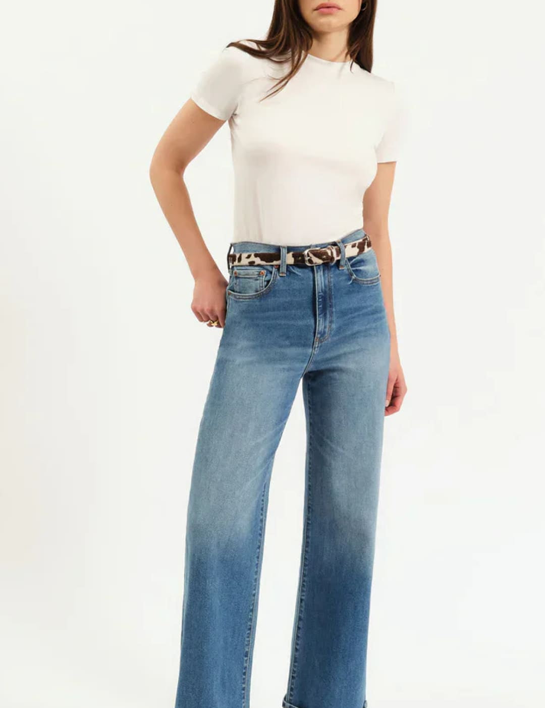High-waisted blue denim jeans with rolled cuffs and a leopard print belt.