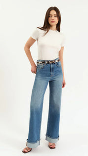 High-waisted blue denim jeans with rolled cuffs and a leopard print belt.
