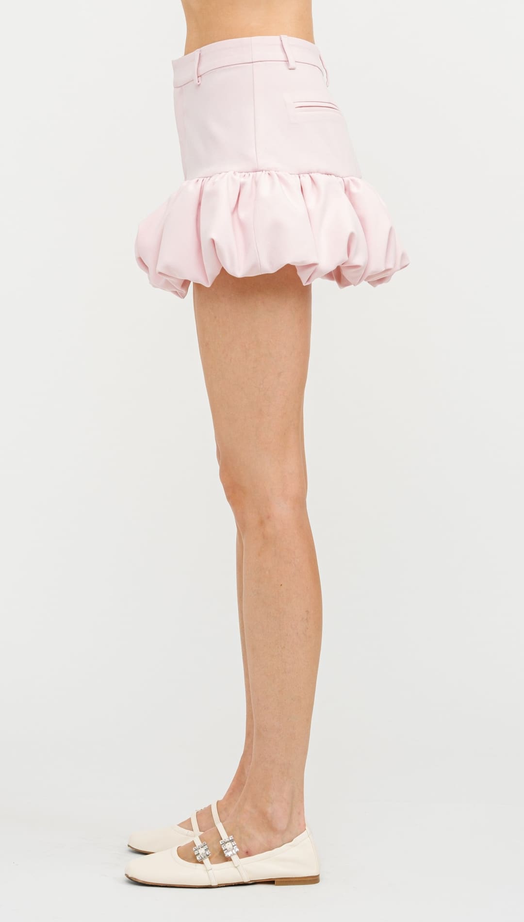 Light pink bubble-hem mini skirt with gathered ruffles.