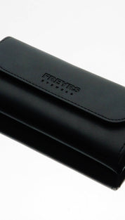 Black leather freyrs eyewear case with stitched flap and embossed branding.