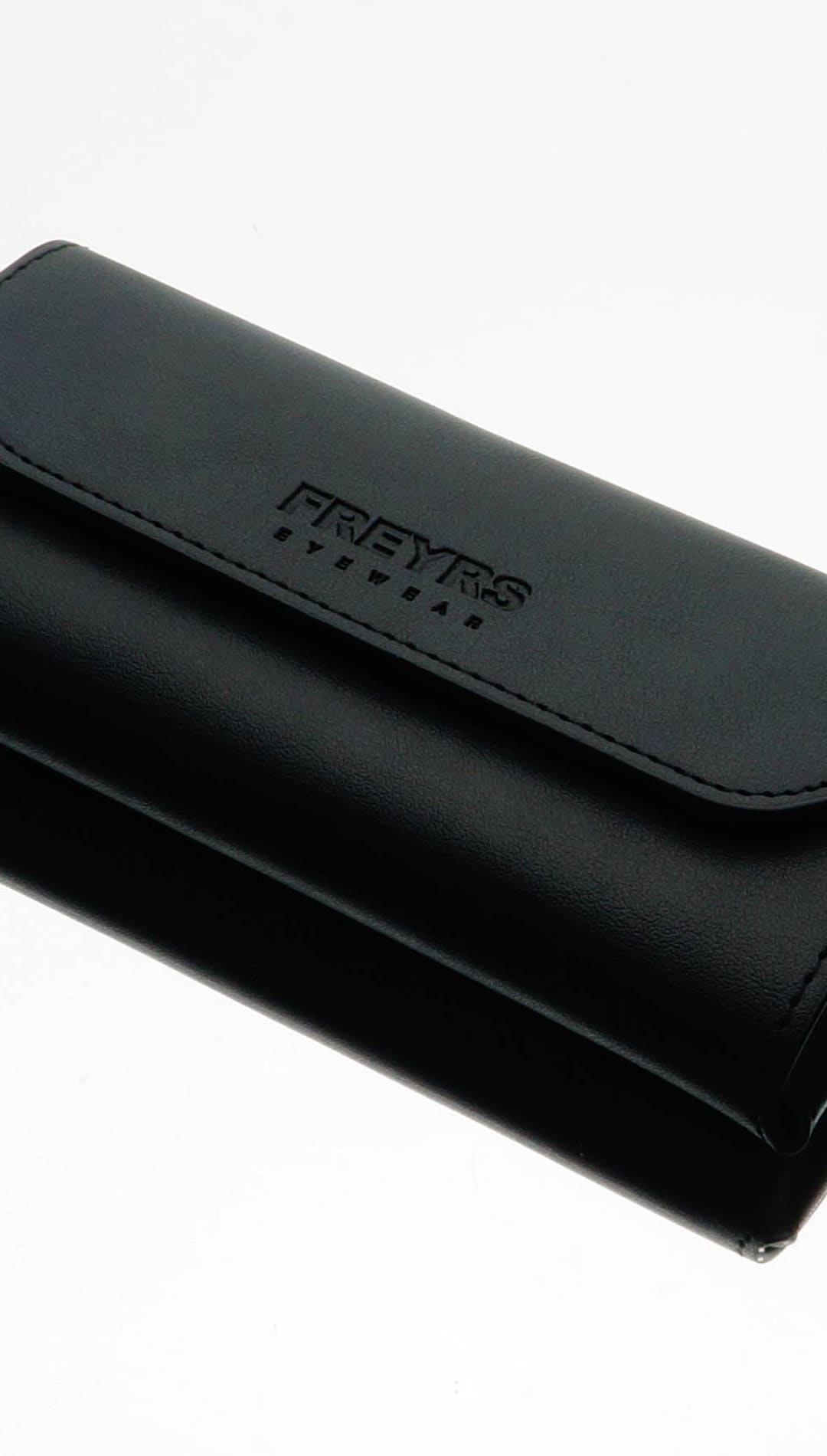 Black leather freyrs eyewear case with stitched flap and embossed branding.